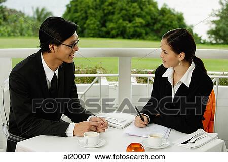 Businesspeople in restaurant, having a discussion View Large Photo Image Stock Photo - Businesspeople in restaurant, having a discussion. Fotosearch