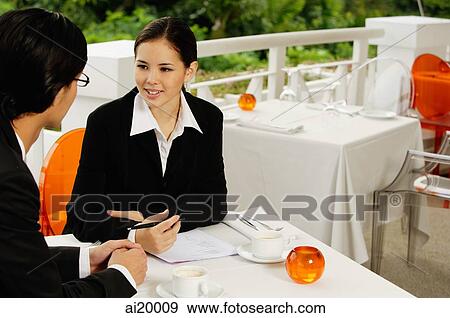 Businesspeople in restaurant, talking View Large Photo Image Stock Photo - Businesspeople in restaurant, talking. Fotosearch