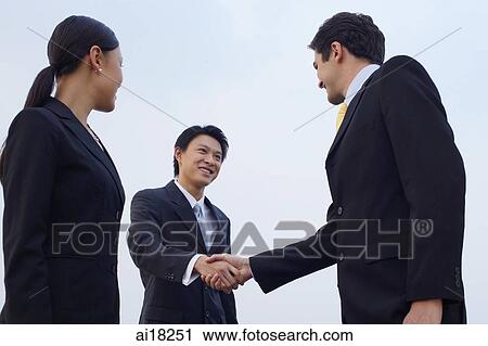 Businesspeople shaking hands, low angle view View Large Photo Image Stock Image - Businesspeople shaking hands, low angle view. Fotosearch