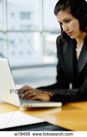 Businesswoman dressed in black, using laptop View Large Photo Image Stock Photo - Businesswoman dressed in black, using laptop. Fotosearch