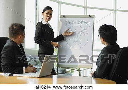 Picture - Businesswoman giving presentation to colleagues. Fotosearch
