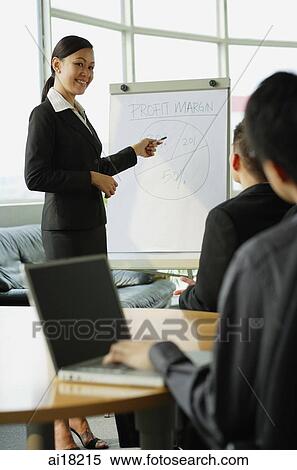 Businesswoman presenting to colleagues View Large Photo Image Stock Photography - Businesswoman presenting to colleagues. Fotosearch
