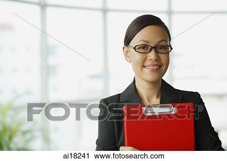 Businesswoman with dark glasses smiling at camera View Large Photo Image Stock Image - Businesswoman with dark glasses smiling at camera. Fotosearch