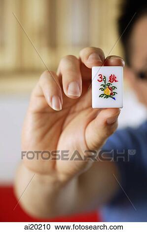 Close-up of hand holding mahjong tile with the Chinese script for Autumn View Large Photo Image Stock Image - Close-up of hand holding mahjong tile with the Chinese script for Autumn. Fotosearch