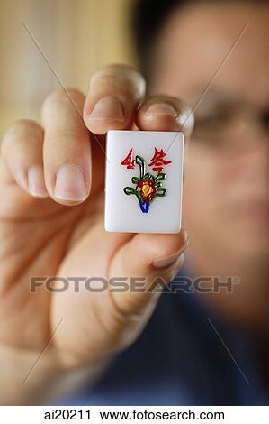 Close-up of hand holding mahjong tile with the Chinese script for Winter View Large Photo Image Stock Image - Close-up of hand holding mahjong tile with the Chinese script for Winter. Fotosearch