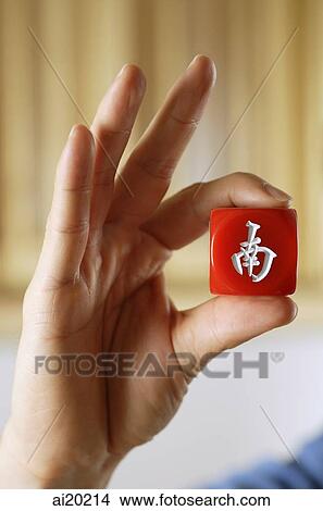 Close-up of hand holding red mahjong tile with Chinese script meaning South View Large Photo Image Picture - Close-up of hand holding red mahjong tile with Chinese script meaning South. Fotosearch
