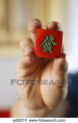 Close-up of hand holding red mahjong tile with Chinese script meaning Luck View Large Photo Image Stock Image - Close-up of hand holding red mahjong tile with Chinese script meaning Luck. Fotosearch