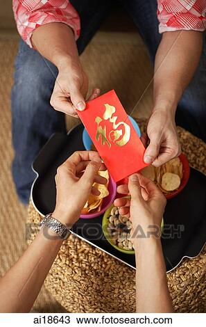 Close up of two pairs of hands, exchanging red packets View Large Photo Image Stock Image - Close up of two pairs of hands, exchanging red packets. Fotosearch