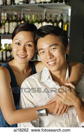 Couple at bar, smiling at camera View Large Photo Image Stock Image - Couple at bar, smiling at camera. Fotosearch