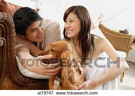 Couple at home with Cocker Spaniel dog View Large Photo Image Stock Photo - Couple at home with Cocker Spaniel dog. Fotosearch