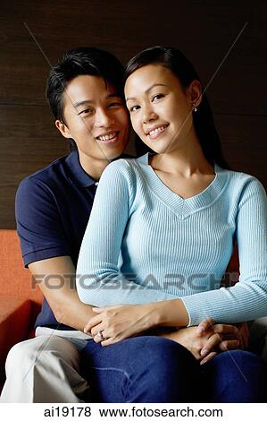 Couple embracing, looking at camera View Large Photo Image Stock Photo - Couple embracing, looking at camera. Fotosearch