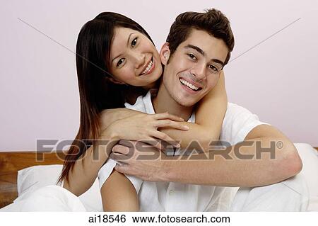 Couple embracing, looking at camera, portrait View Large Photo Image Stock Photograph - Couple embracing, looking at camera, portrait. Fotosearch