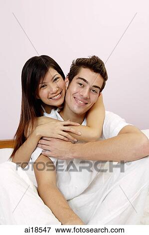 Couple embracing, woman hugging man from behind View Large Photo Image Stock Photo - Couple embracing, woman hugging man from behind. Fotosearch