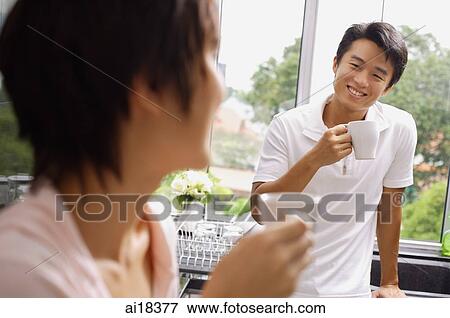 Couple having coffee in kitchen, selective focus View Large Photo Image Stock Photo - Couple having coffee in kitchen, selective focus. Fotosearch