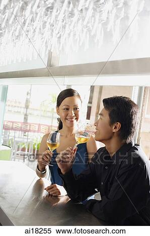 Couple having drinks at bar View Large Photo Image Stock Photography - Couple having drinks at bar. Fotosearch