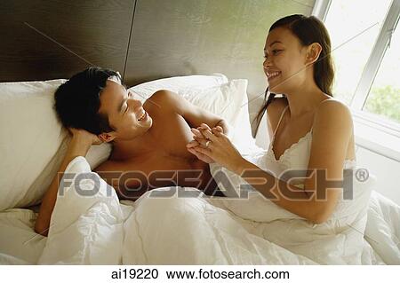 Couple in bedroom, holding hands View Large Photo Image Stock Image - Couple in bedroom, holding hands. Fotosearch