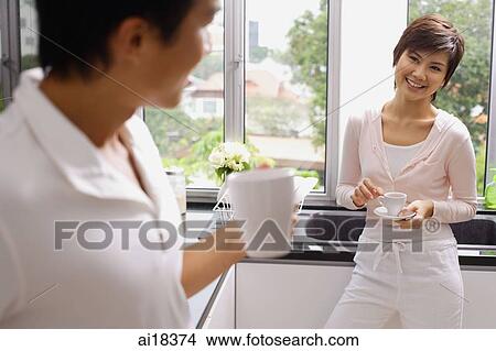 Couple in kitchen having coffee View Large Photo Image Picture - Couple in kitchen having coffee. Fotosearch