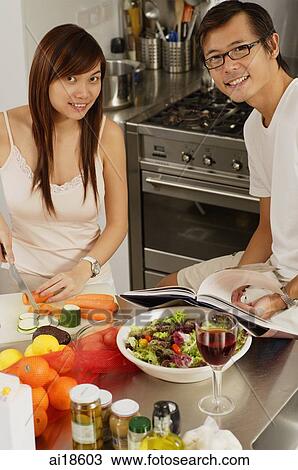Couple in kitchen, smiling at camera View Large Photo Image Stock Image - Couple in kitchen, smiling at camera. Fotosearch