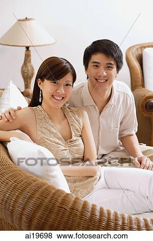Couple in living room, portrait View Large Photo Image Stock Photo - Couple in living room, portrait. Fotosearch