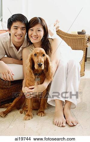 Couple in living room, with Cocker Spaniel dog View Large Photo Image Picture - Couple in living room, with Cocker Spaniel dog. Fotosearch
