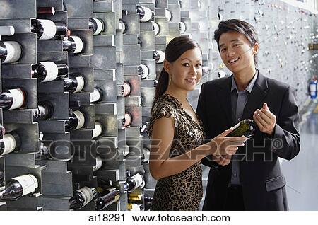 Couple in wine cellar, looking at camera View Large Photo Image Stock Image - Couple in wine cellar, looking at camera. Fotosearch