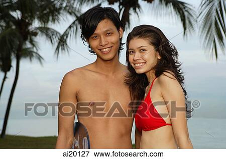 Couple on beach, looking at camera, portrait View Large Photo Image Stock Photo - Couple on beach, looking at camera, portrait. Fotosearch