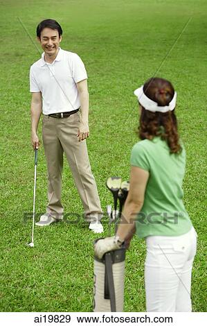 Couple on golf course View Large Photo Image Stock Photo - Couple on golf course. Fotosearch