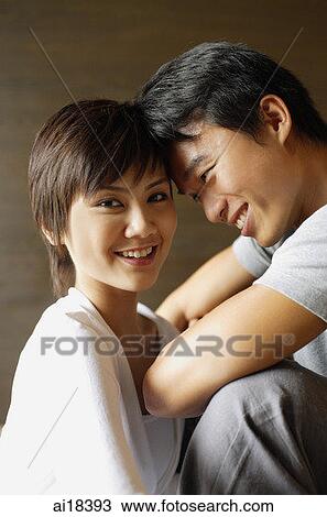 Couple sitting with foreheads touching, woman smiling at camera View Large Photo Image Stock Image - Couple sitting with foreheads touching, woman smiling at camera. Fotosearch