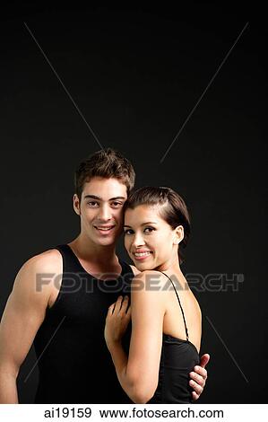 Couple standing cheek to cheek, smiling at camera View Large Photo Image Stock Photo - Couple standing cheek to cheek, smiling at camera. Fotosearch