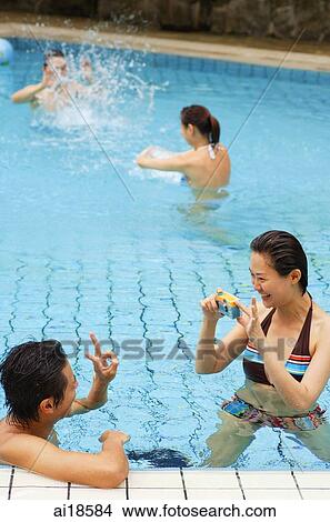 Picture - Couples in swimming pool. Fotosearch