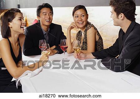 Couples sitting in restaurant, drinking wine and talking View Large Photo Image Stock Image - Couples sitting in restaurant, drinking wine and talking. Fotosearch