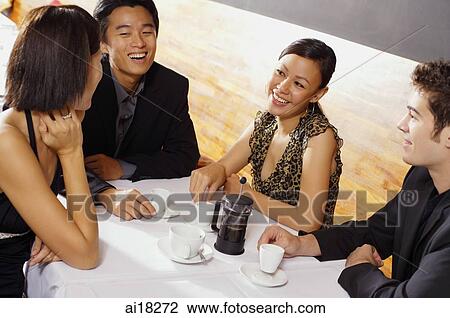 Couples sitting in restaurant, having coffee View Large Photo Image Stock Image - Couples sitting in restaurant, having coffee. Fotosearch