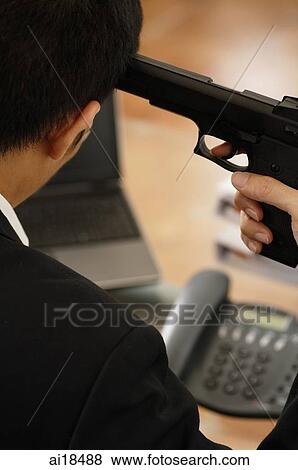 Stock Photo - Executive holding a gun to his head, over the shoulder view. Fotosearch