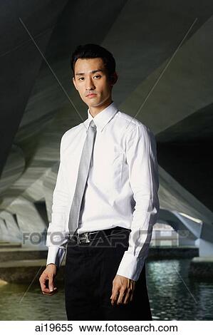 Executive in shirt and tie, looking at camera View Large Photo Image Stock Photography - Executive in shirt and tie, looking at camera. Fotosearch
