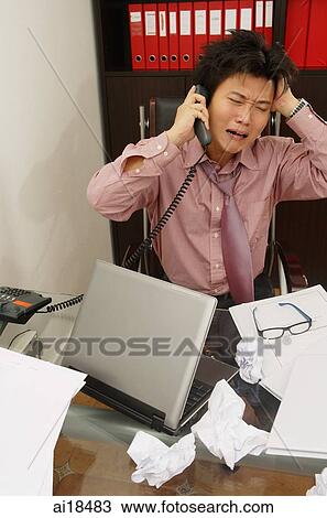 Executive with tousled hair, sitting at messy desk, using phone View Large Photo Image Stock Image - Executive with tousled hair, sitting at messy desk, using phone. Fotosearch