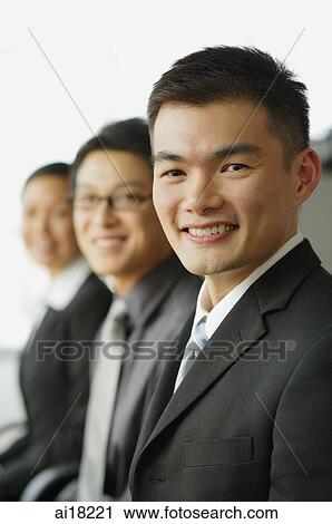 Executives in a row, focus on the businessman in foreground View Large Photo Image Stock Image - Executives in a row, focus on the businessman in foreground. Fotosearch