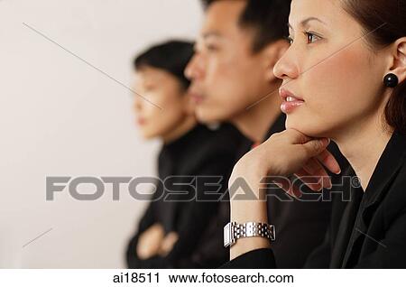 Executives sitting in a row, focus on the woman in the foreground View Large Photo Image Stock Image - Executives sitting in a row, focus on the woman in the foreground. Fotosearch