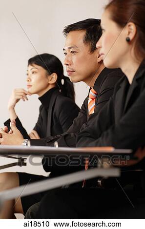 Stock Image - Executives sitting in a row. Fotosearch