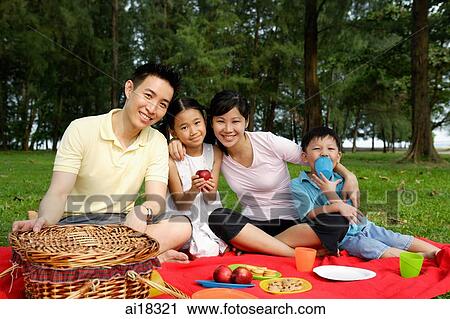 Family of four, having a picnic, smiling at camera View Large Photo Image Stock Image - Family of four, having a picnic, smiling at camera. Fotosearch