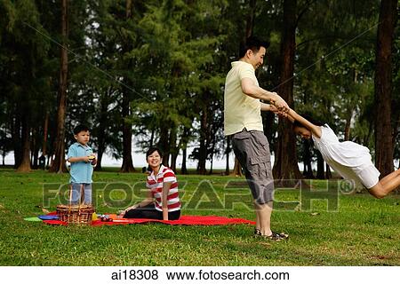 Family of four in park View Large Photo Image Stock Photo - Family of four in park. Fotosearch