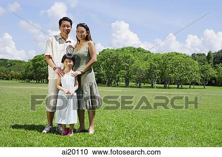 Family of three standing in field, looking at camera View Large Photo Image Stock Image - Family of three standing in field, looking at camera. Fotosearch