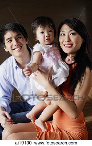 Family with one child, looking at camera, portrait View Large Photo Image Stock Image - Family with one child, looking at camera, portrait. Fotosearch
