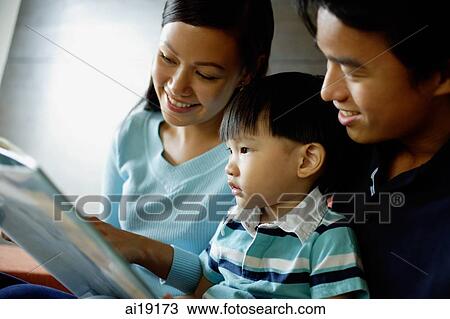 Family with one child reading a book View Large Photo Image Stock Image - Family with one child reading a book. Fotosearch