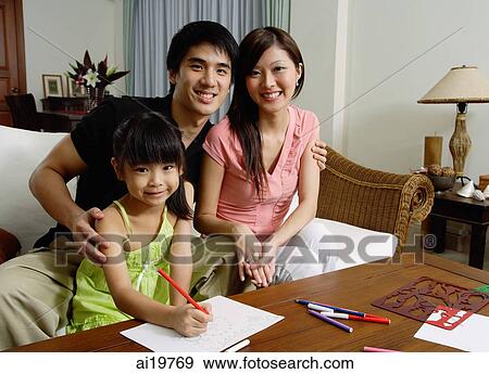 Stock Photo - Family with one daughter, looking at camera. Fotosearch