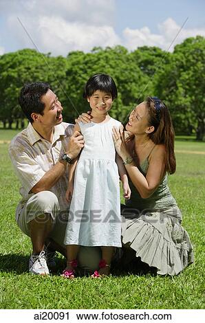 Father and mother looking at daughter between them View Large Photo Image Stock Image - Father and mother looking at daughter between them. Fotosearch