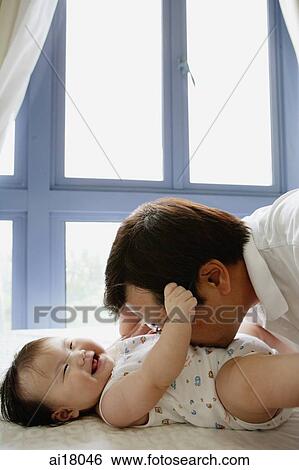Father kissing baby girl on stomach View Large Photo Image Stock Photograph - Father kissing baby girl on stomach. Fotosearch