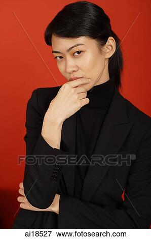 Female executive looking at camera, arms crossed, hand on chin View Large Photo Image Stock Photo - Female executive looking at camera, arms crossed, hand on chin. Fotosearch