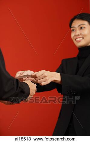 Female executive offering business card to another executive View Large Photo Image Stock Photo - Female executive offering business card to another executive. Fotosearch