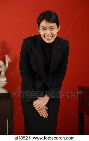 Female executive smiling and bowing View Large Photo Image Stock Image - Female executive smiling and bowing. Fotosearch