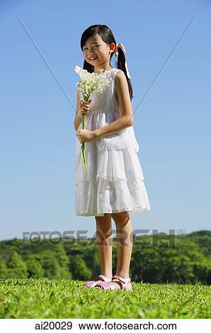 Girl holding bouquet of flowers View Large Photo Image Stock Photo - Girl holding bouquet of flowers. Fotosearch